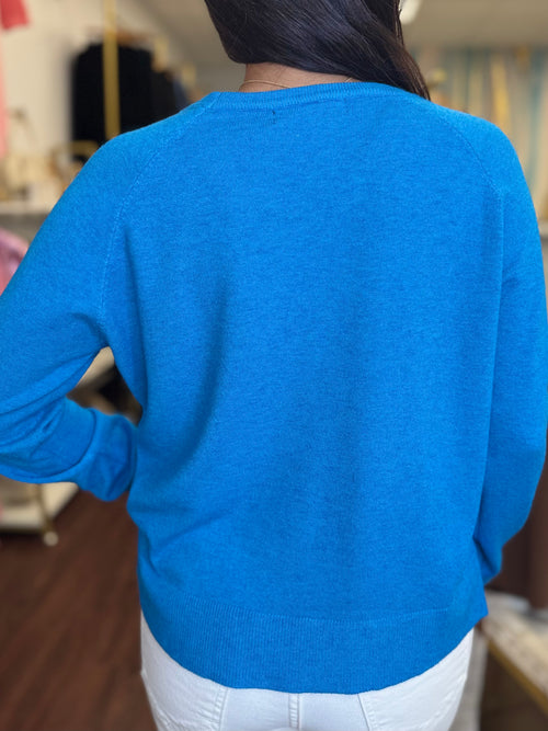 Turquoise sweater side slit hem detail