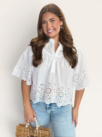 White eyelet short sleeve top with feminine cutwork detail on sleeves and hem